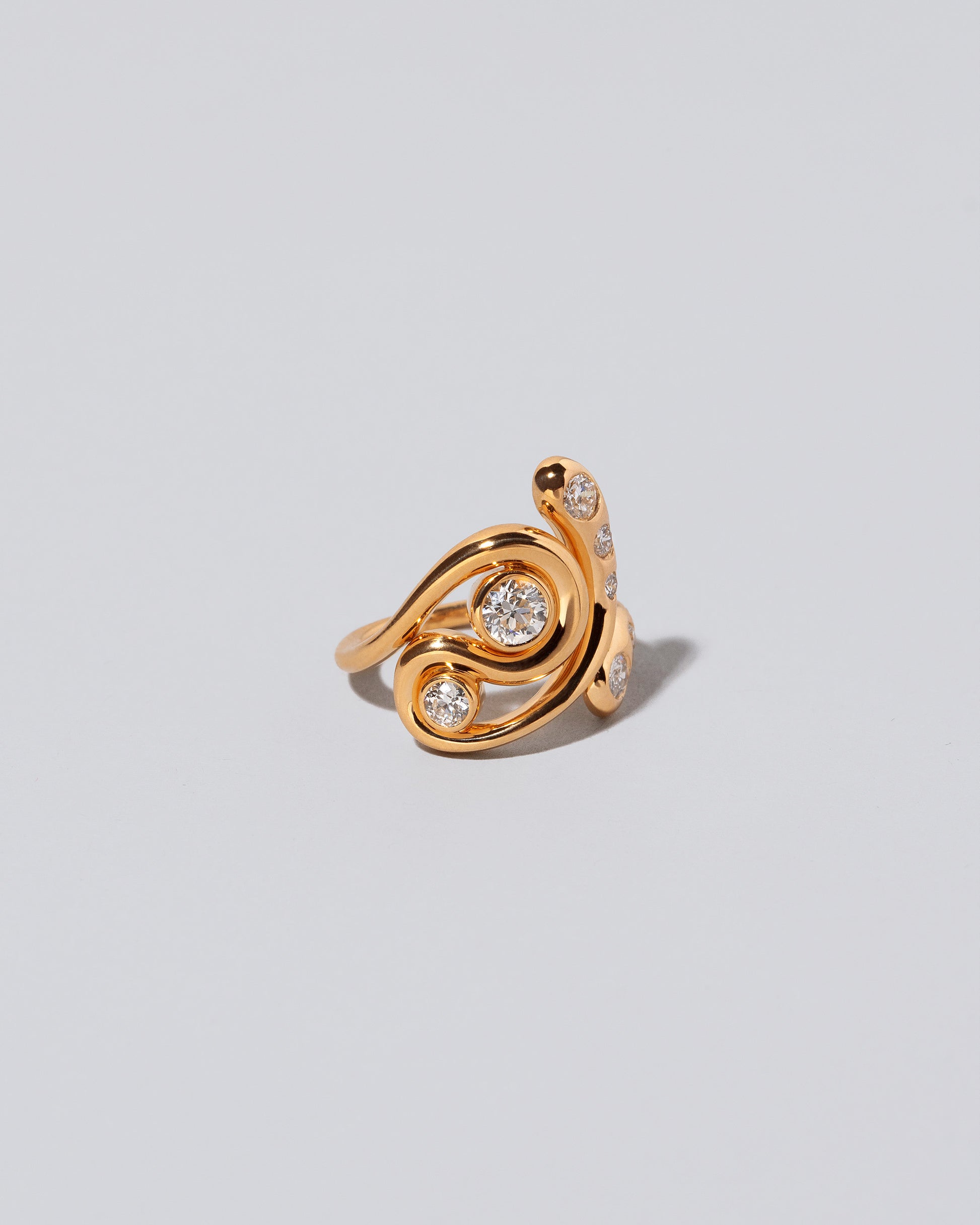 View from the side of the Twist It Ring on light color background.
