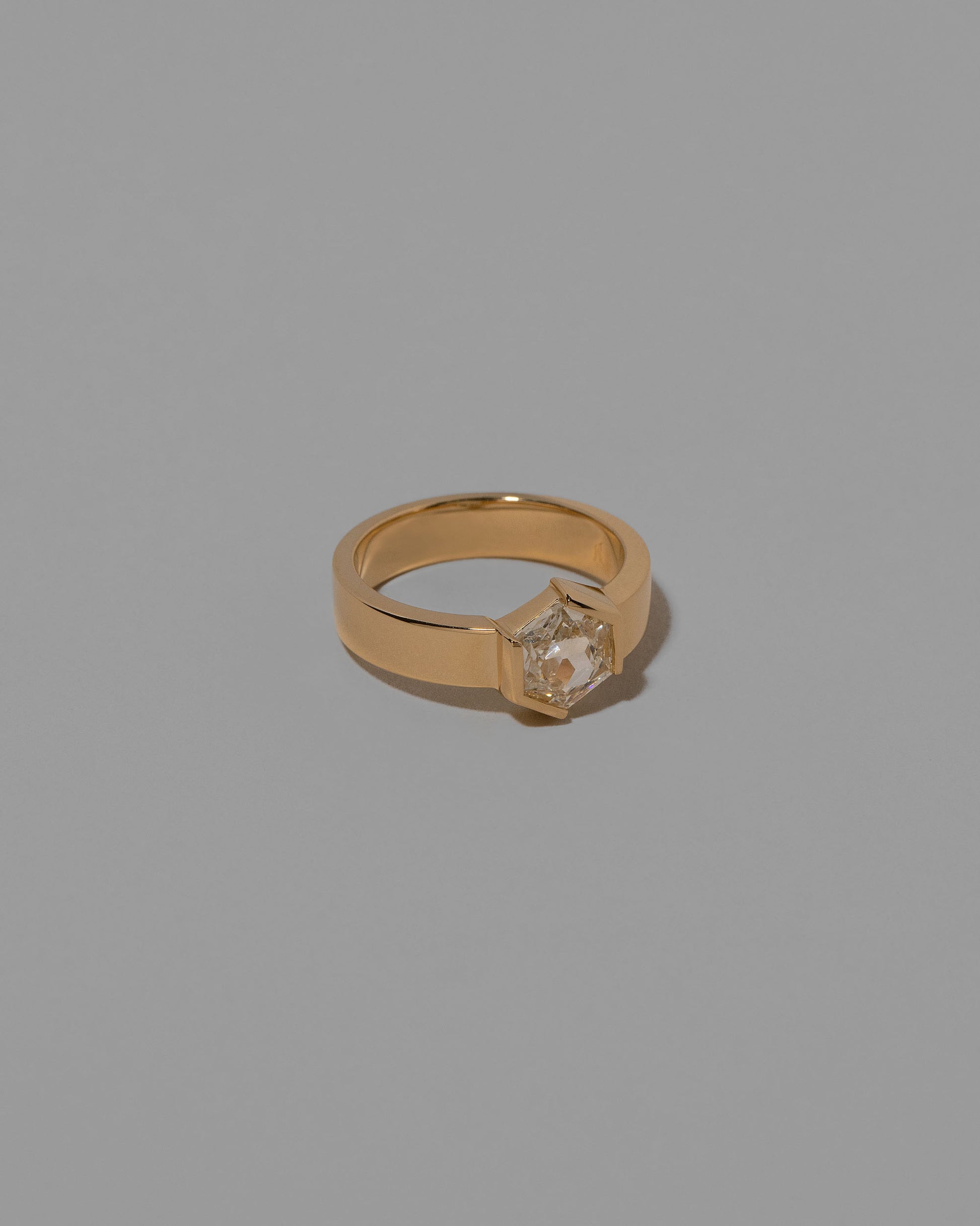 View from the side of the Devotion Ring on light color background.