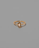 Adulation Ring on light color background.
