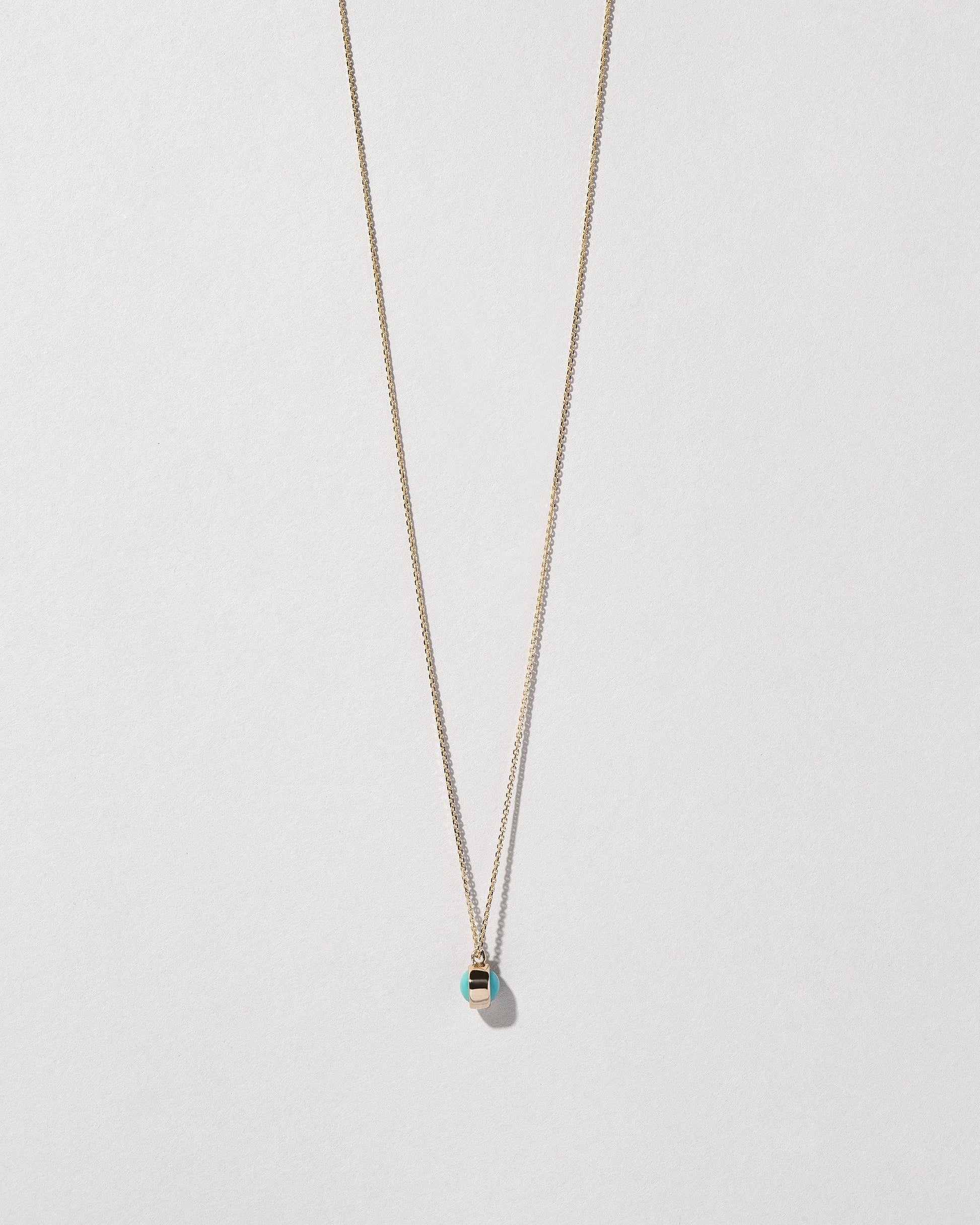Turquoise Birthstone Necklace on light color background.
