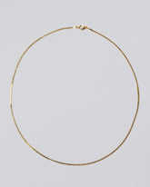 Yellow Gold Serpentina Chain Necklace on light color background.