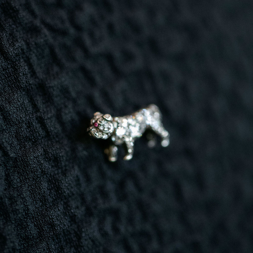 product_details::Closeup details of the Antique Diamond & Ruby-Eyed English Bulldog Brooch on dark color background.
