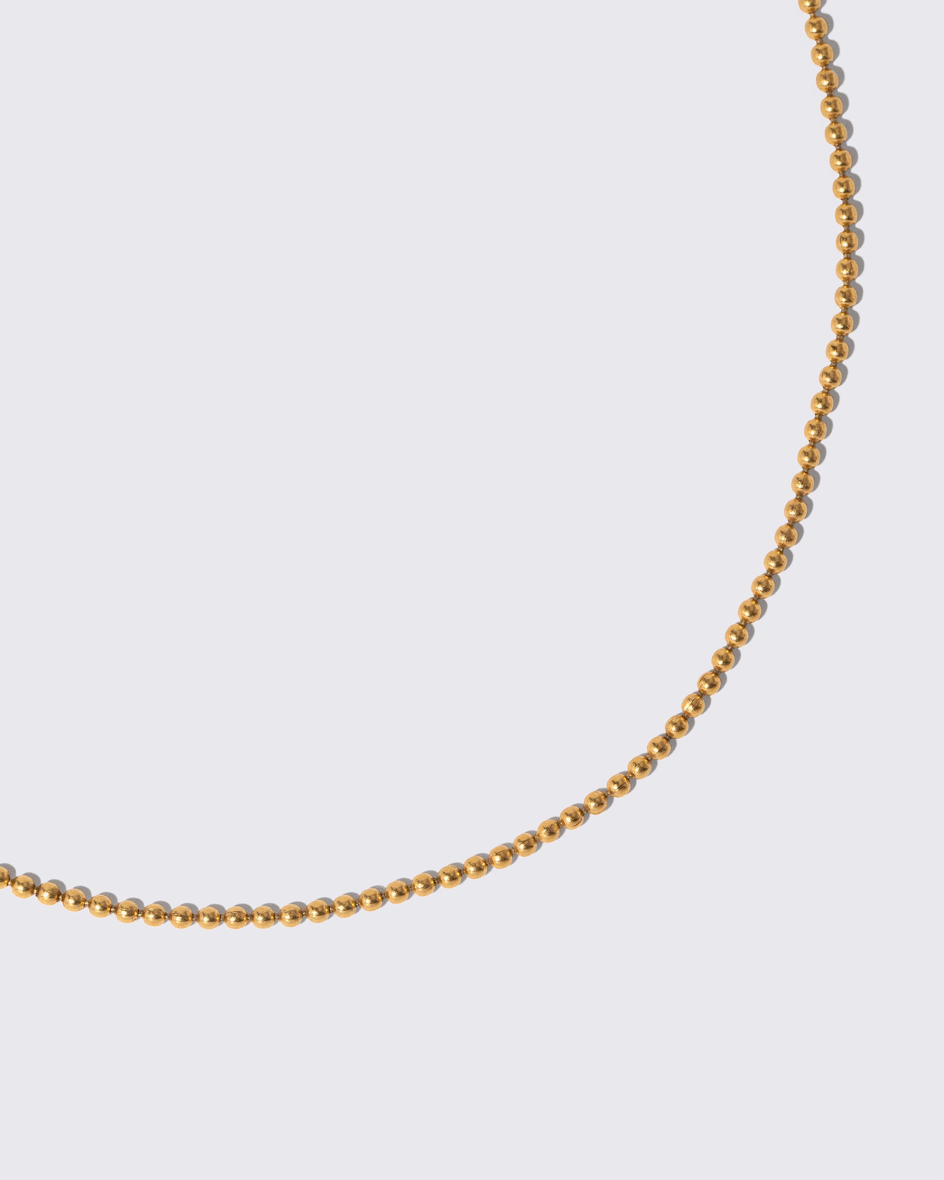 Closeup details of the Vintage Ball Chain Necklace on light color background.