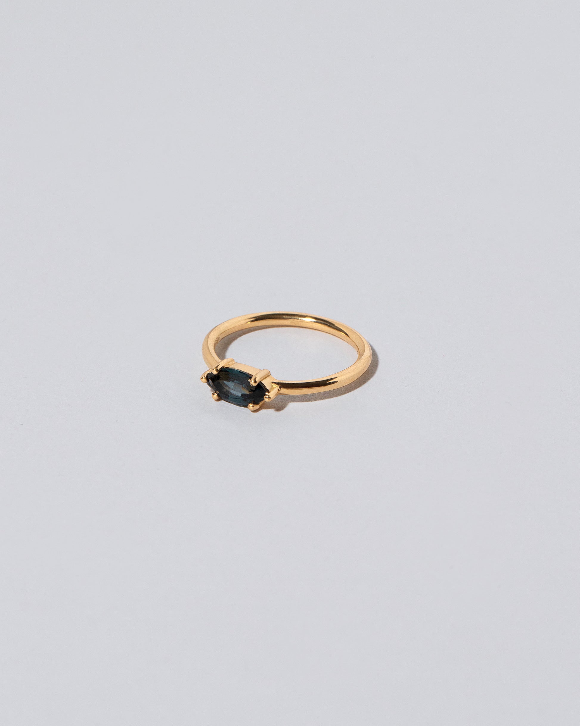 View from the side of the Deep Blue Ouvert Ring on light color background.