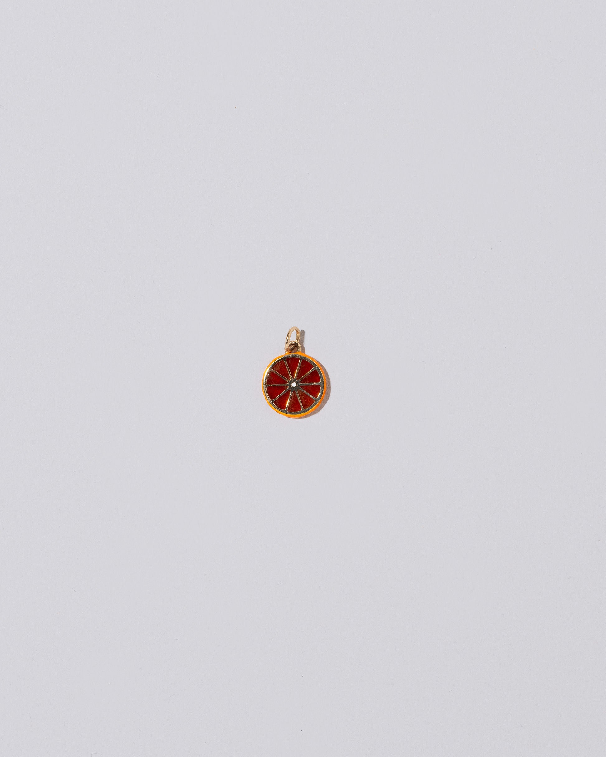 Large Tangerine Slice Charm on light color background.