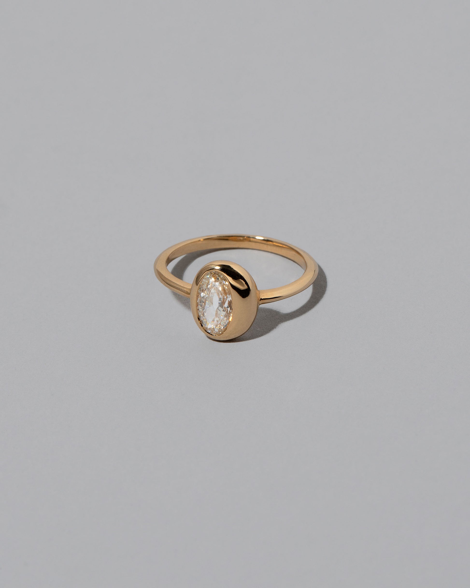 View from the side of the Moval Diamond Precise Ring on light color background.