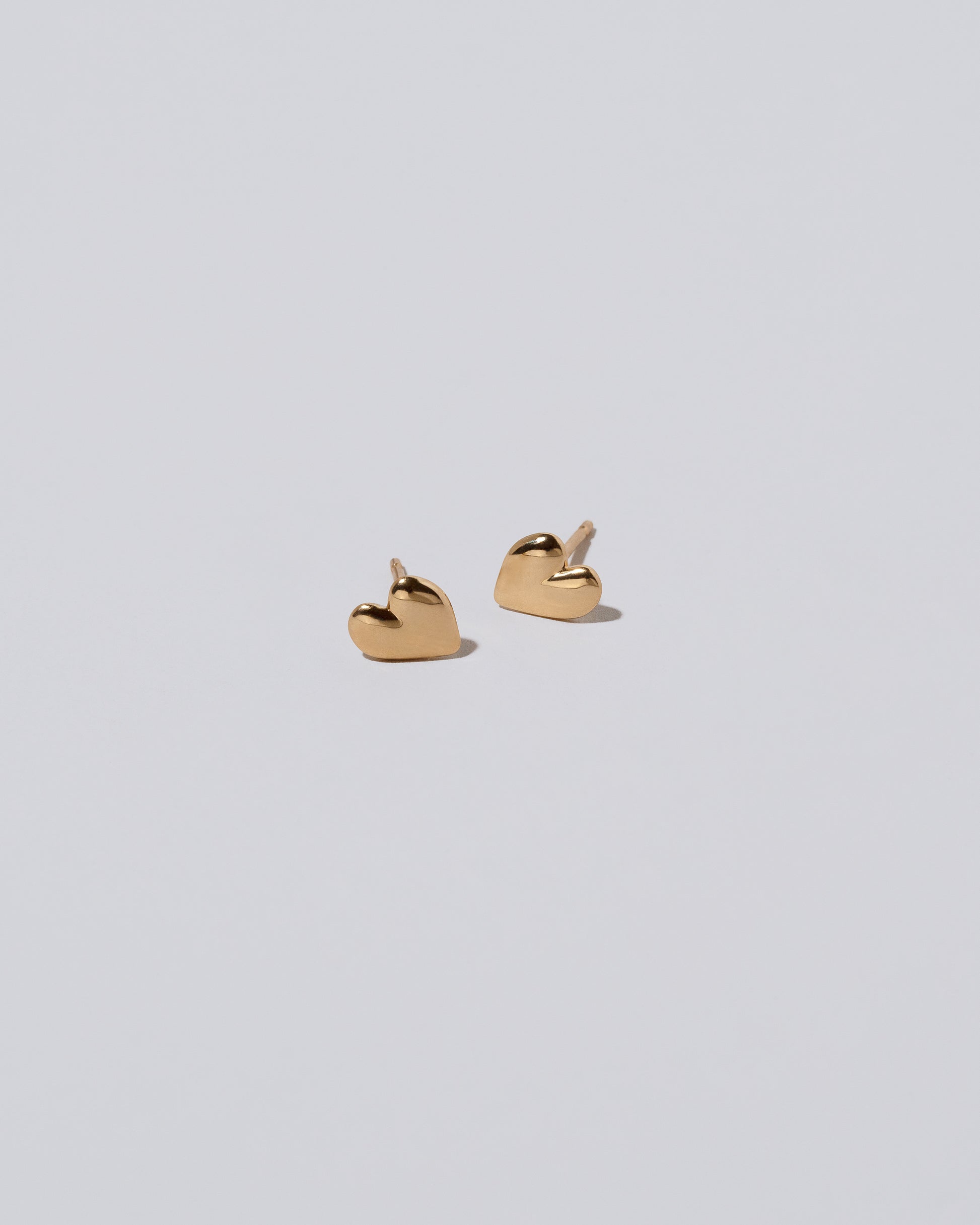 Shape One Thousand & One Night Heart Stud Earrings on light color background.
