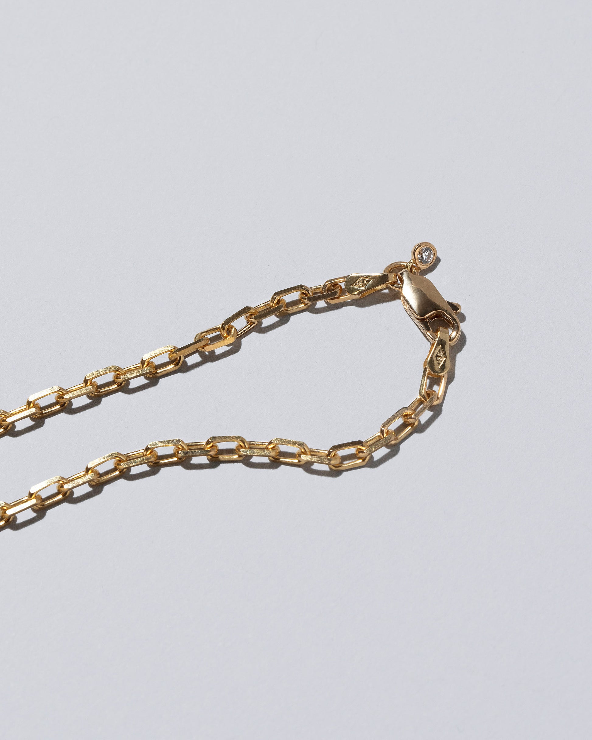 View from the back of the Field of Love Necklace on light color background.