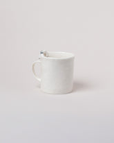 Eleonor Boström Hiding Dog Mug on light color background.
