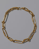 CRZM Gold Ophiolite Necklace on light color background.