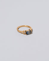 View from the side of the Blue Sapphire Expression Ring on light color background.