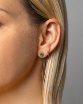 Gold Emerald Fold Earrings and Huggie Gold Diamond Snack Hoop Earrings on model.