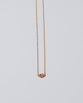 Light Pink Big Kiss Necklace on light color background.