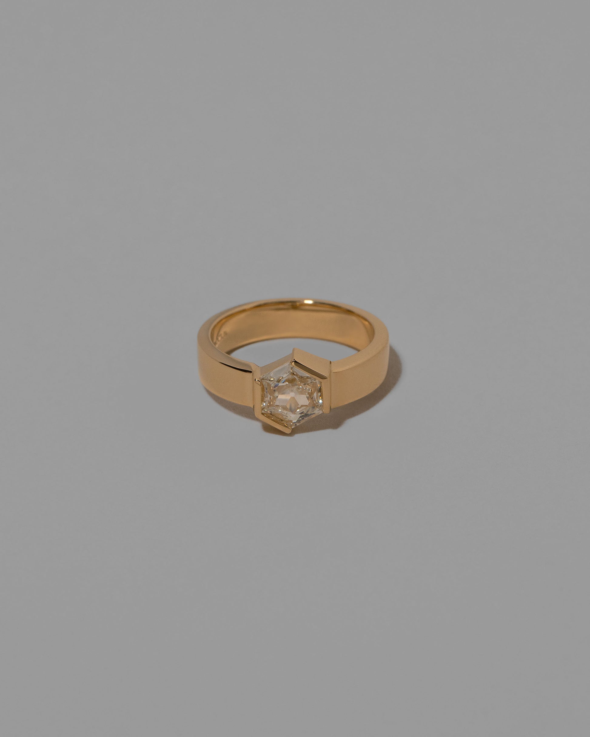 Devotion Ring on light color background.