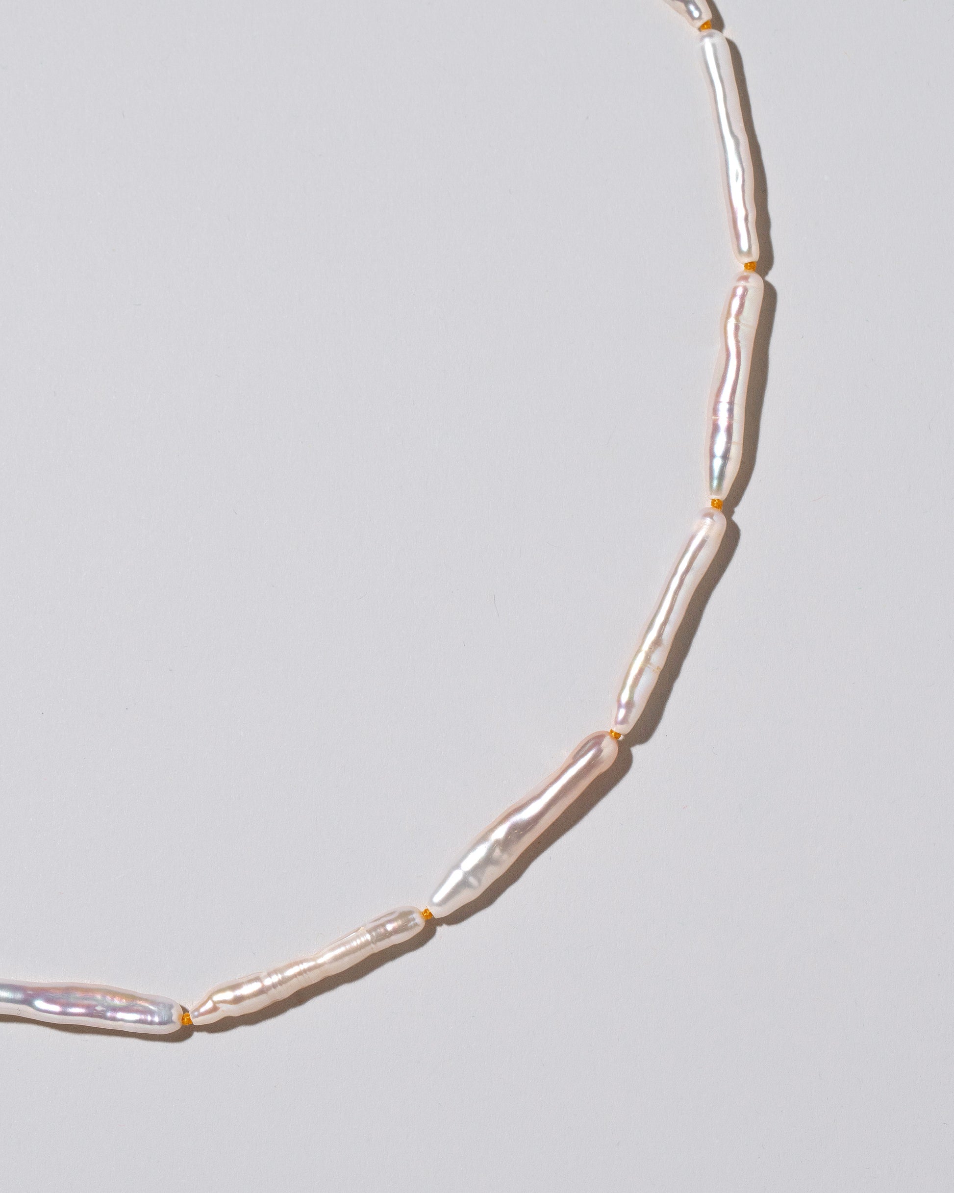 Stick Pearl Strand Necklace on light color background.