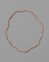 Pink Peony Baroque Pearl Necklace on light color background.