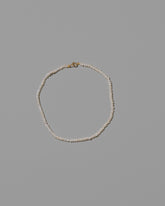 White Pebble Seed Pearl Anklet on light color background.