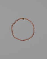 Pink Seed Pearl Anklet on light color background.