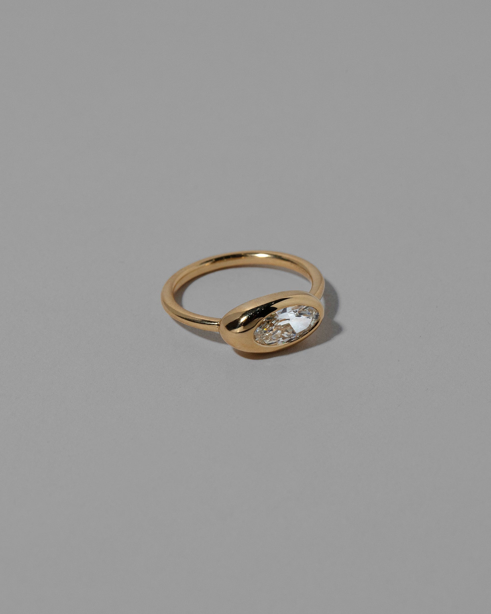 View from the side of a past version of the  Moval White Diamond Equalize Ring on light color background.