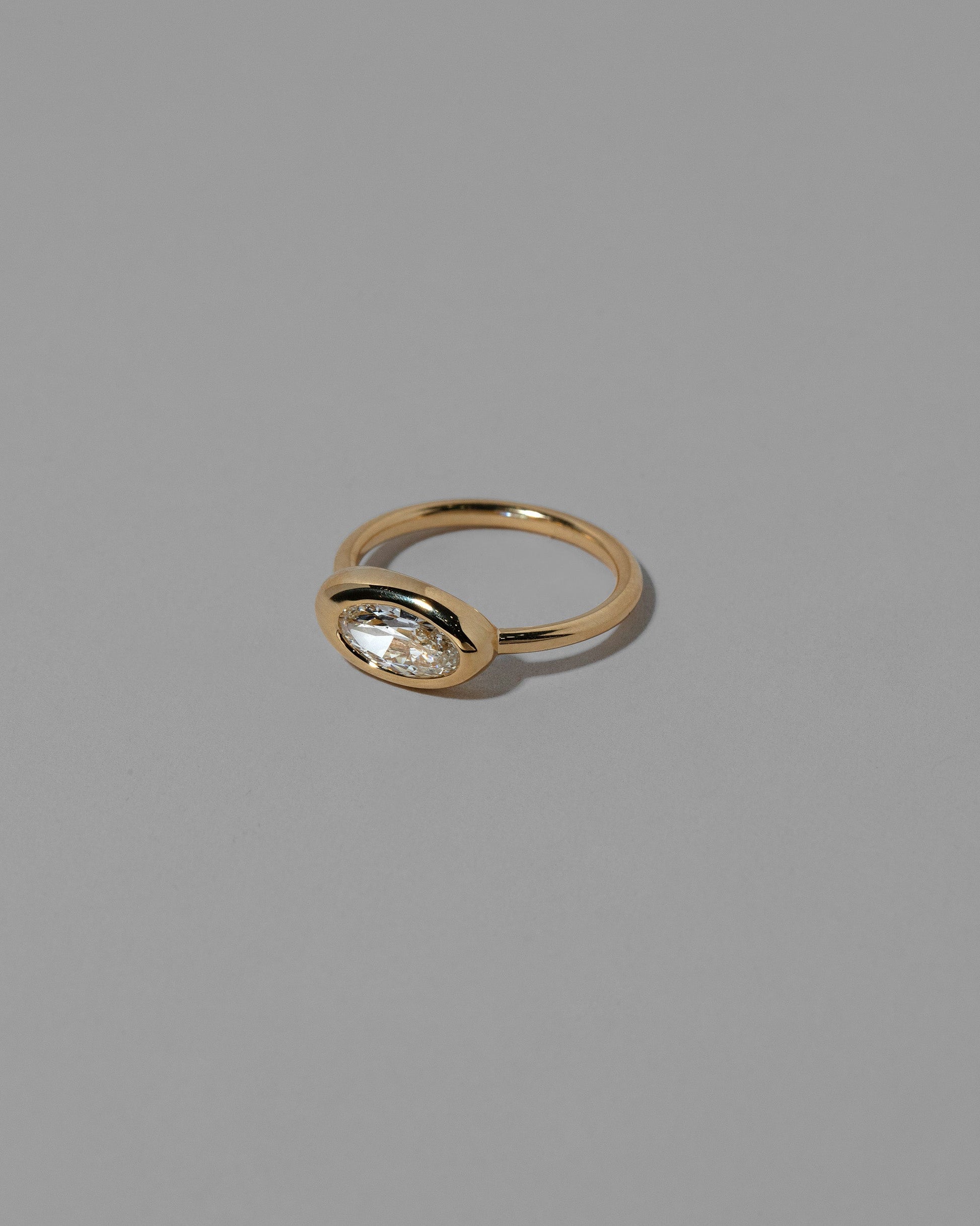 View from the side of a past version of the  Moval White Diamond Equalize Ring on light color background.