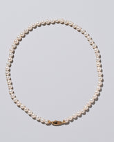 Closeup detail of the Blue Pearl & White Gold Union Pearl Necklace on light color background.
