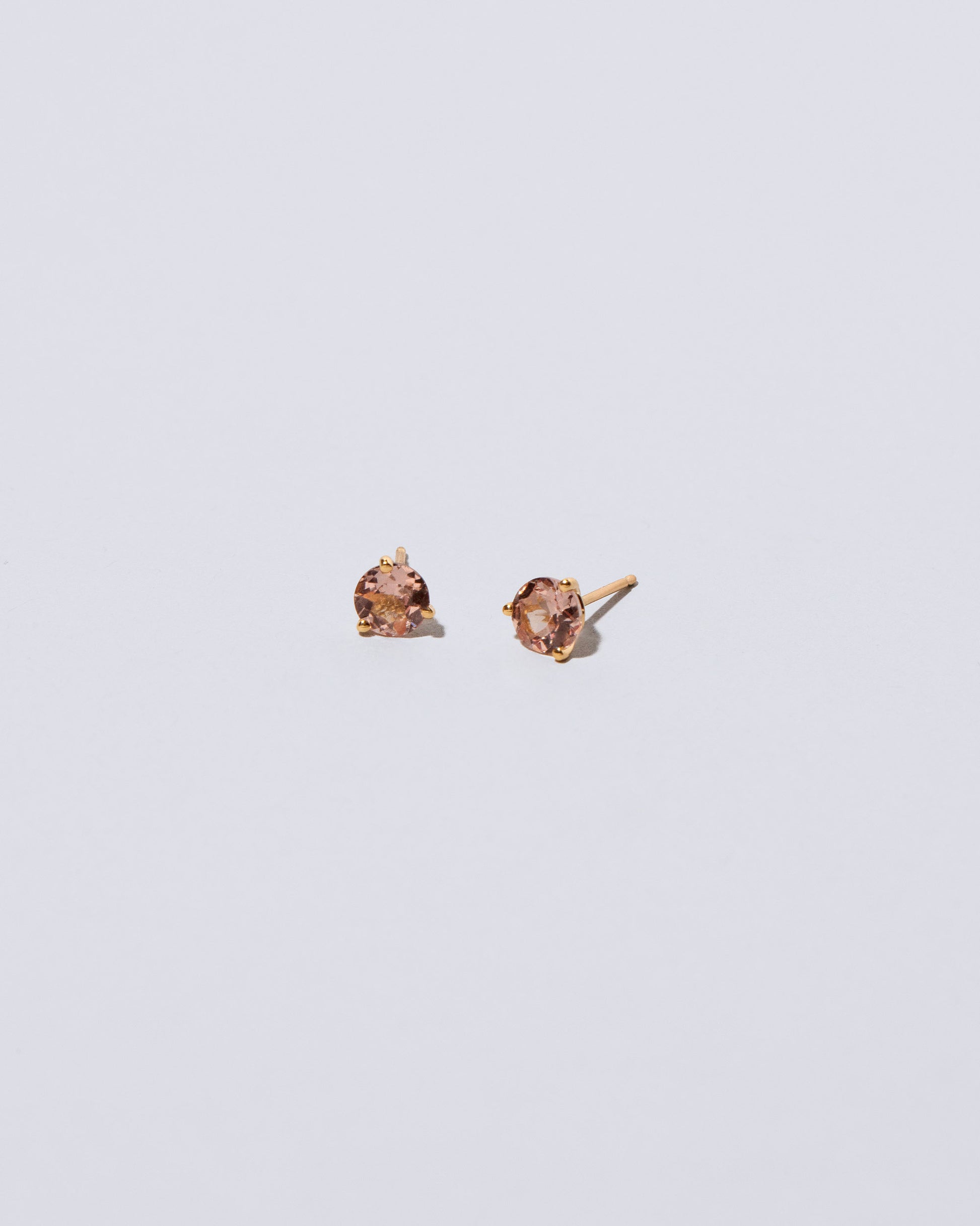 Mega Lotus Garnet Martini Stud Earrings on light color background.