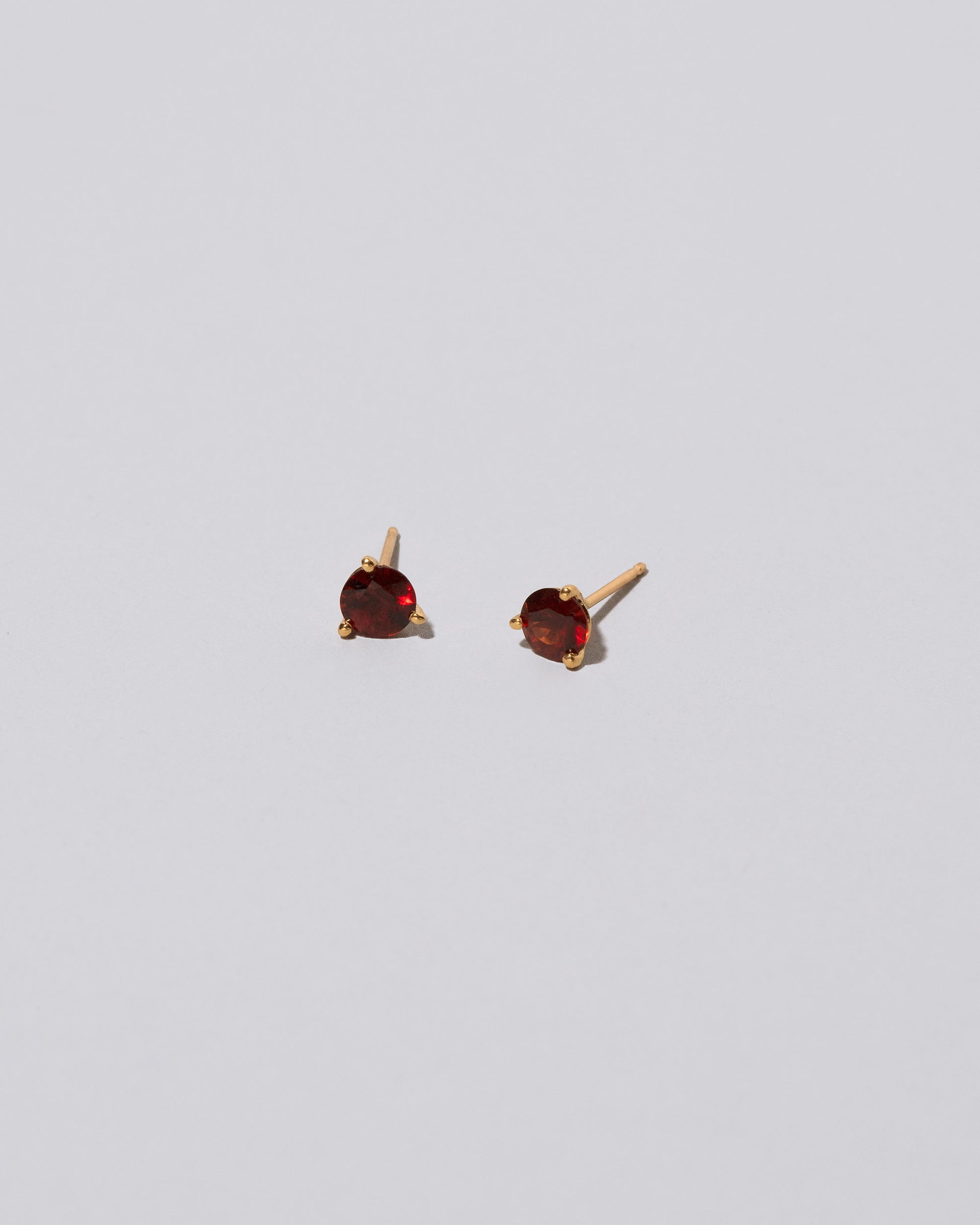 Mega Red Garnet Martini Stud Earrings on light color background.