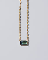 Closeup details of the Attunement Necklace on light color background.