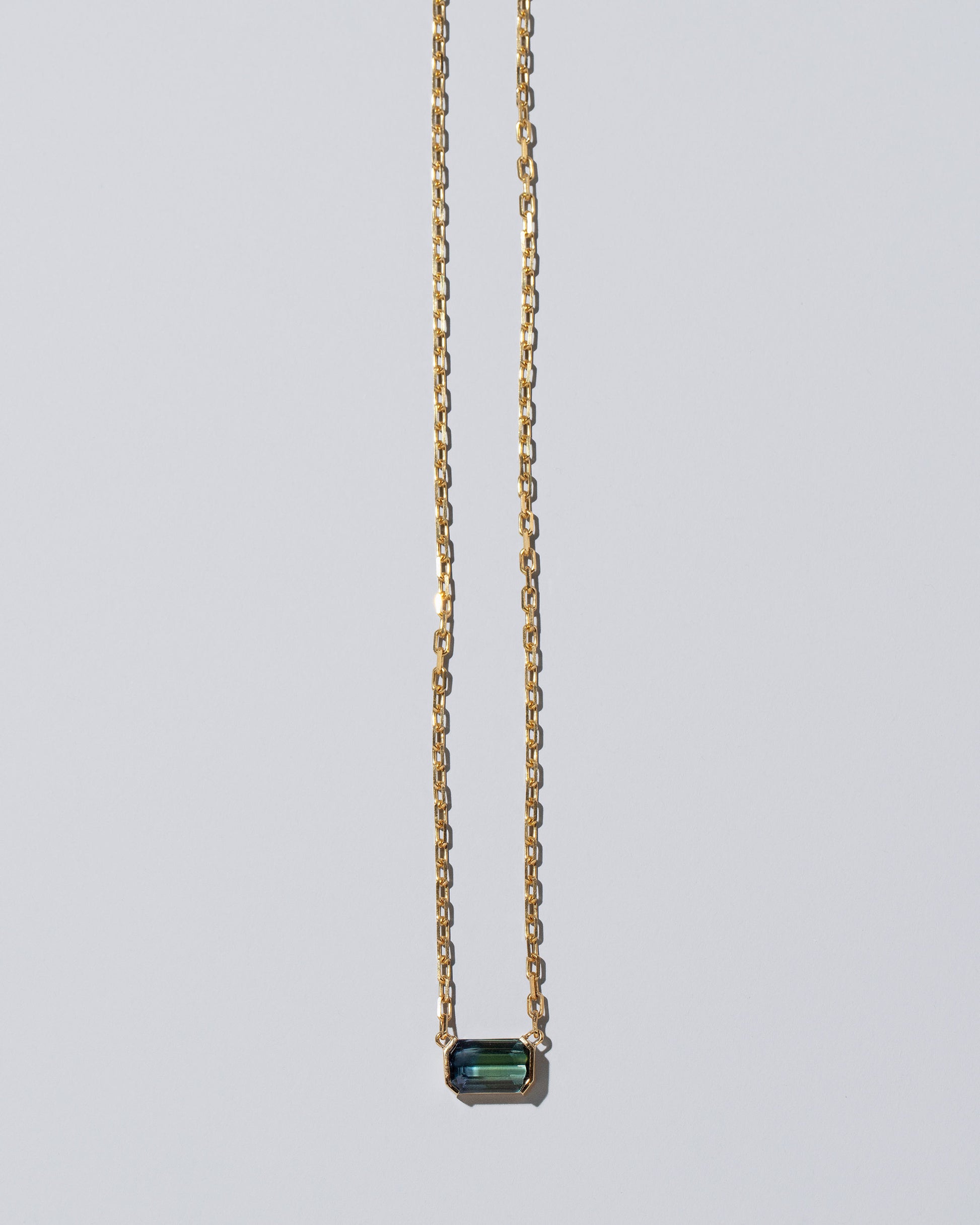 Attunement Necklace on light color background.
