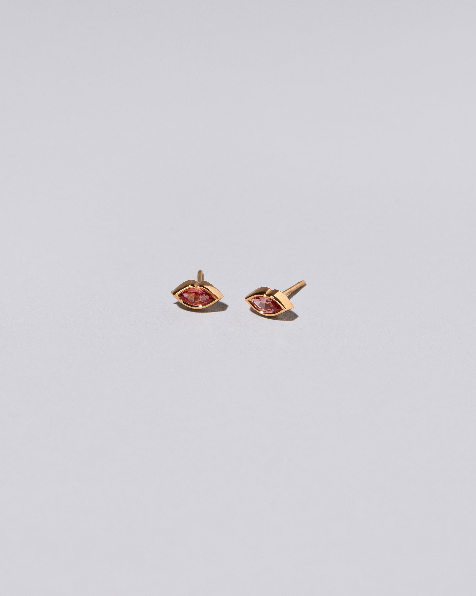 Pink Kiss Stud Earrings on light color background.