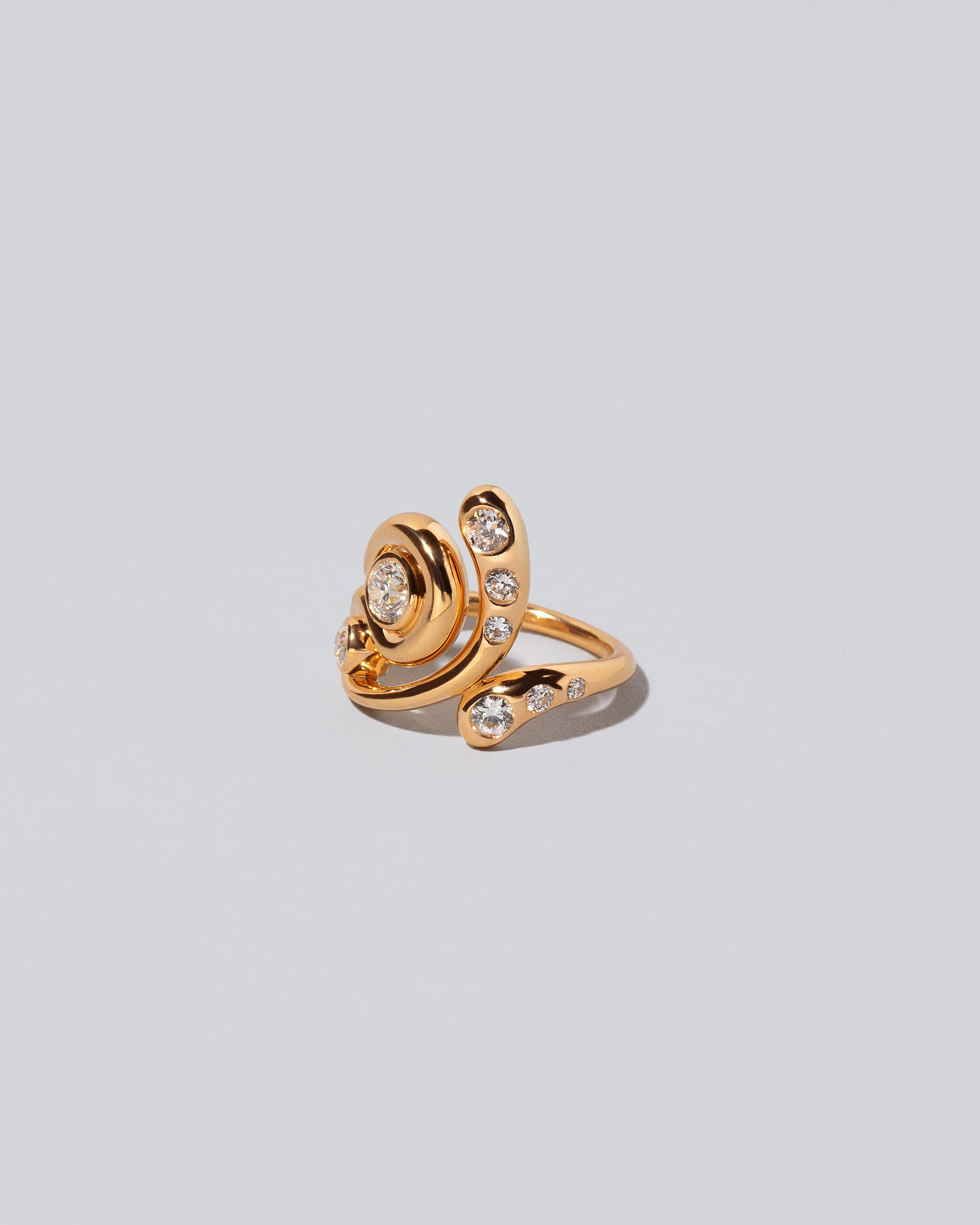 View from the side of the Twist It Ring on light color background.