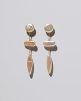 Heron Pearl Earrings on light color background.