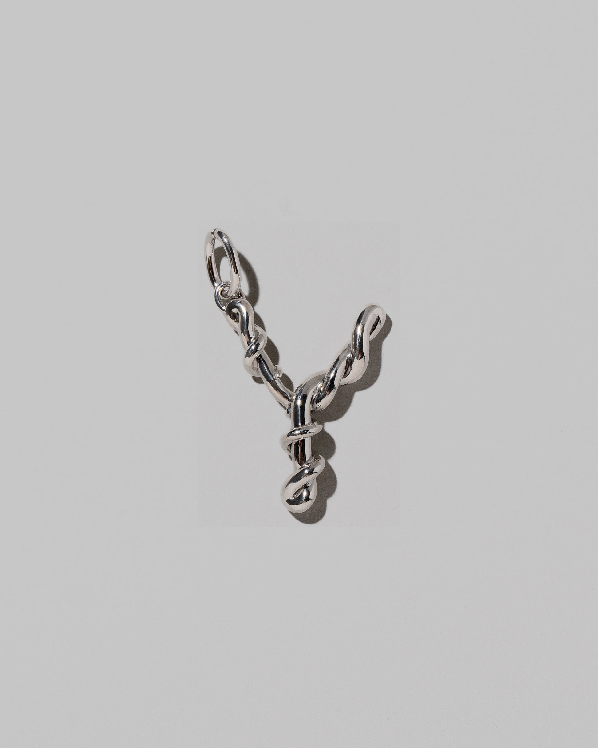 CRZM Large Letter Y Charm set in sterling silver on light color background.
