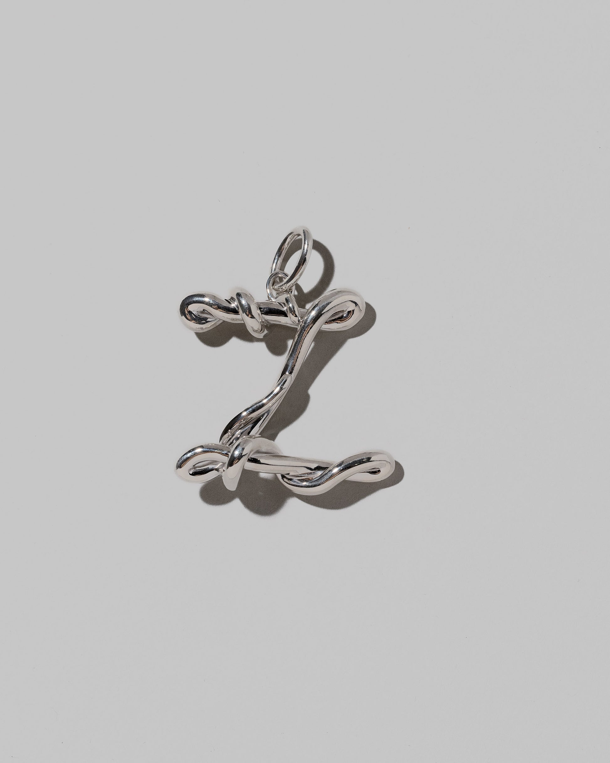 CRZM Large Letter Z Charm set in sterling silver on light color background.