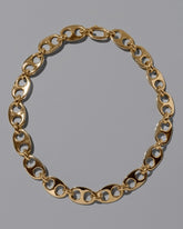 CRZM Gold Yuba Necklace on light color background.