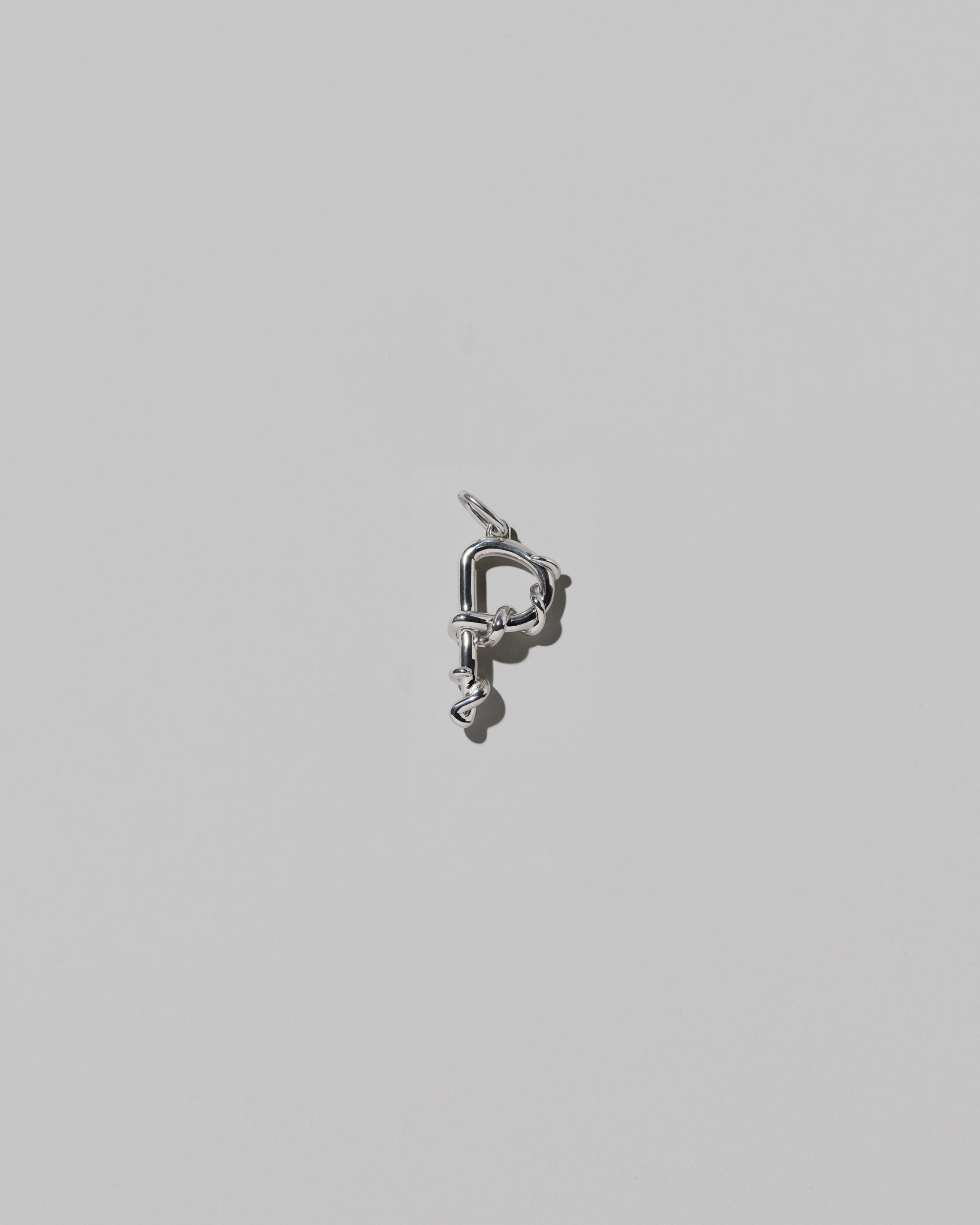 CRZM Medium Letter P Charm set in sterling silver on light color background.