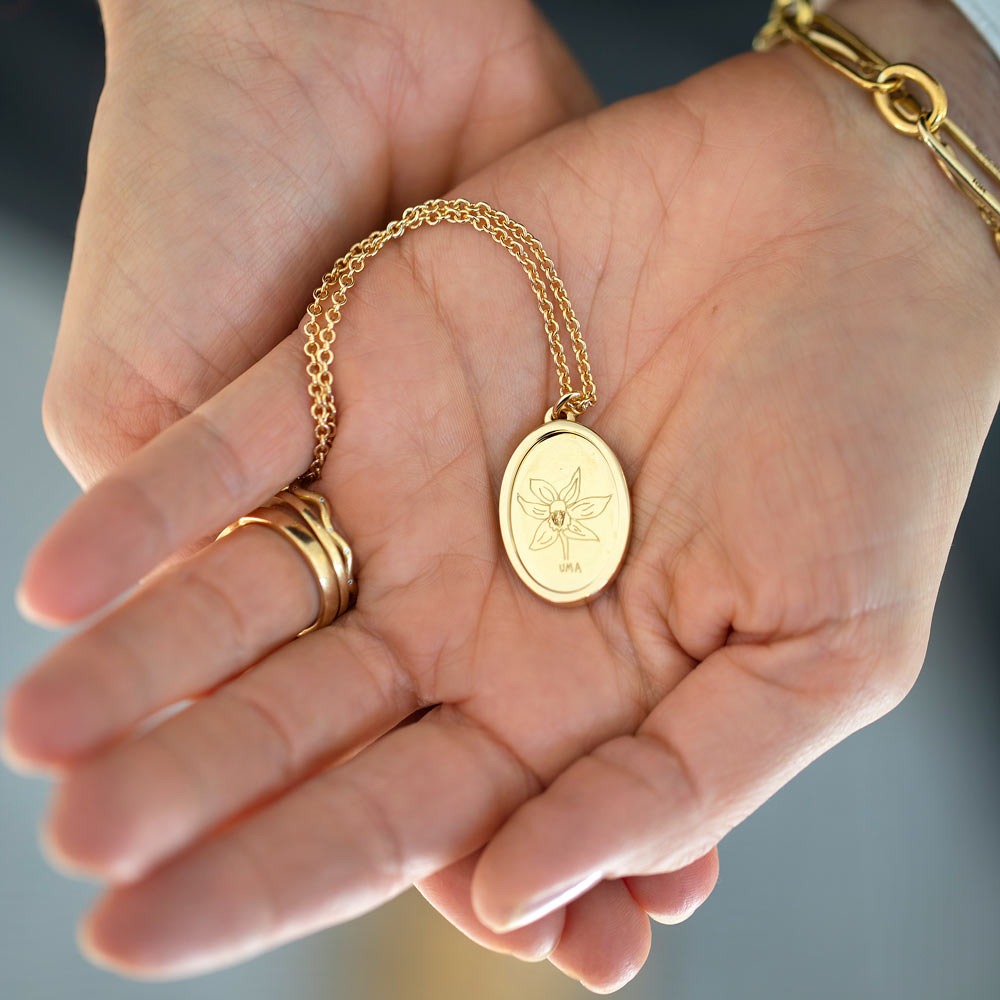 product_details::Finished Large Oval Memento Necklace engraved with children's drawing in hand.