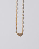 Closeup details of the Adamas Necklace on light color background.