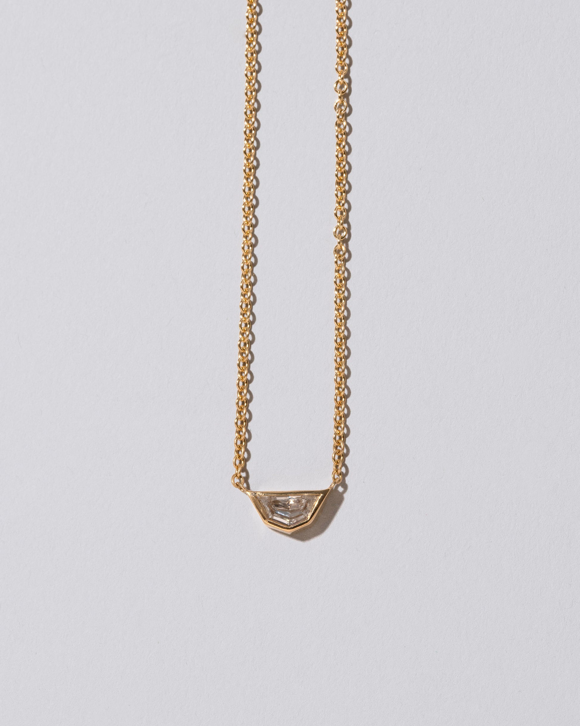 Closeup details of the Adamas Necklace on light color background.