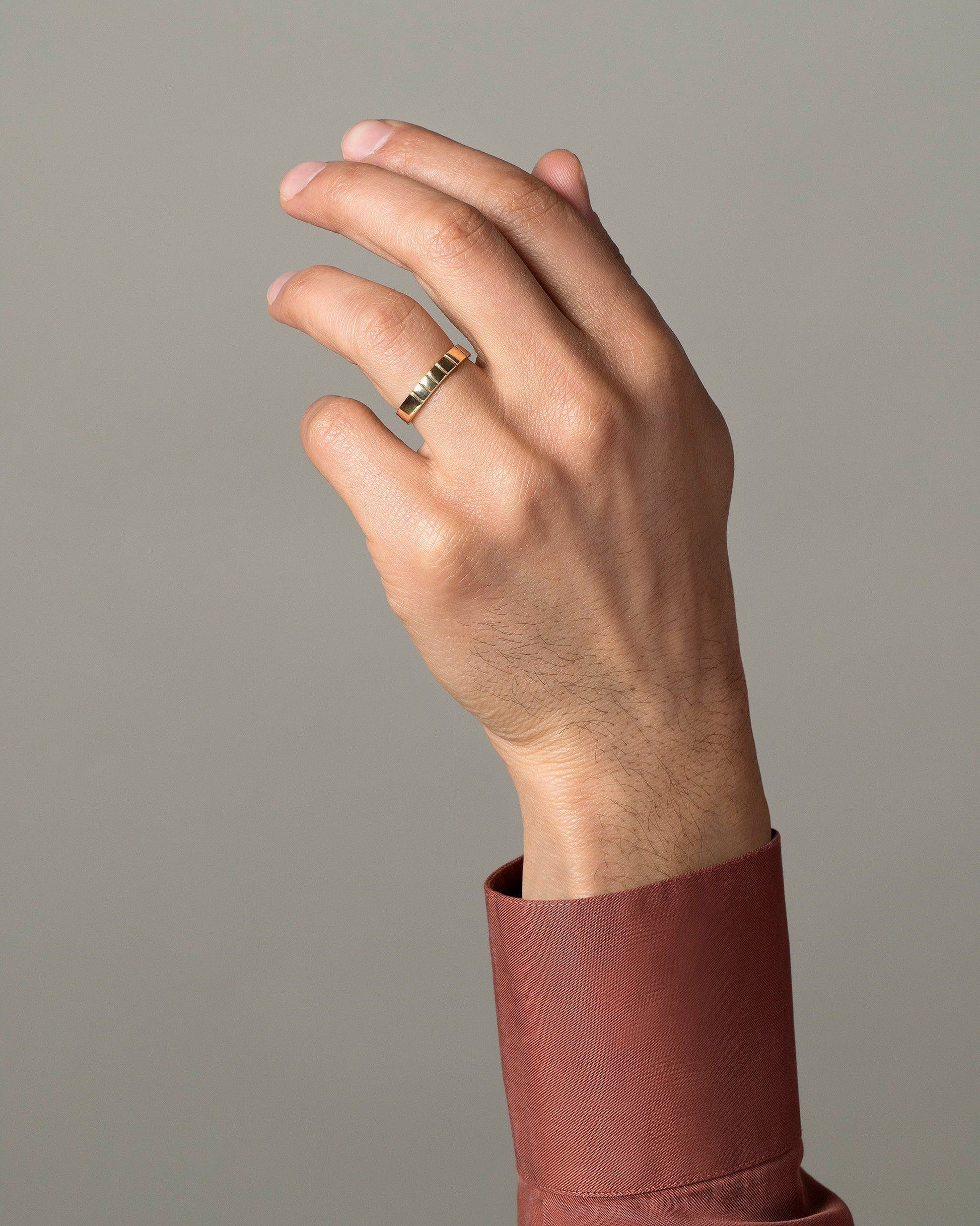 Gold 4mm Etched Lines Band on male model.