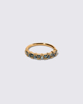 Teal Sapphire Eleven Trillion Ring on light color background.