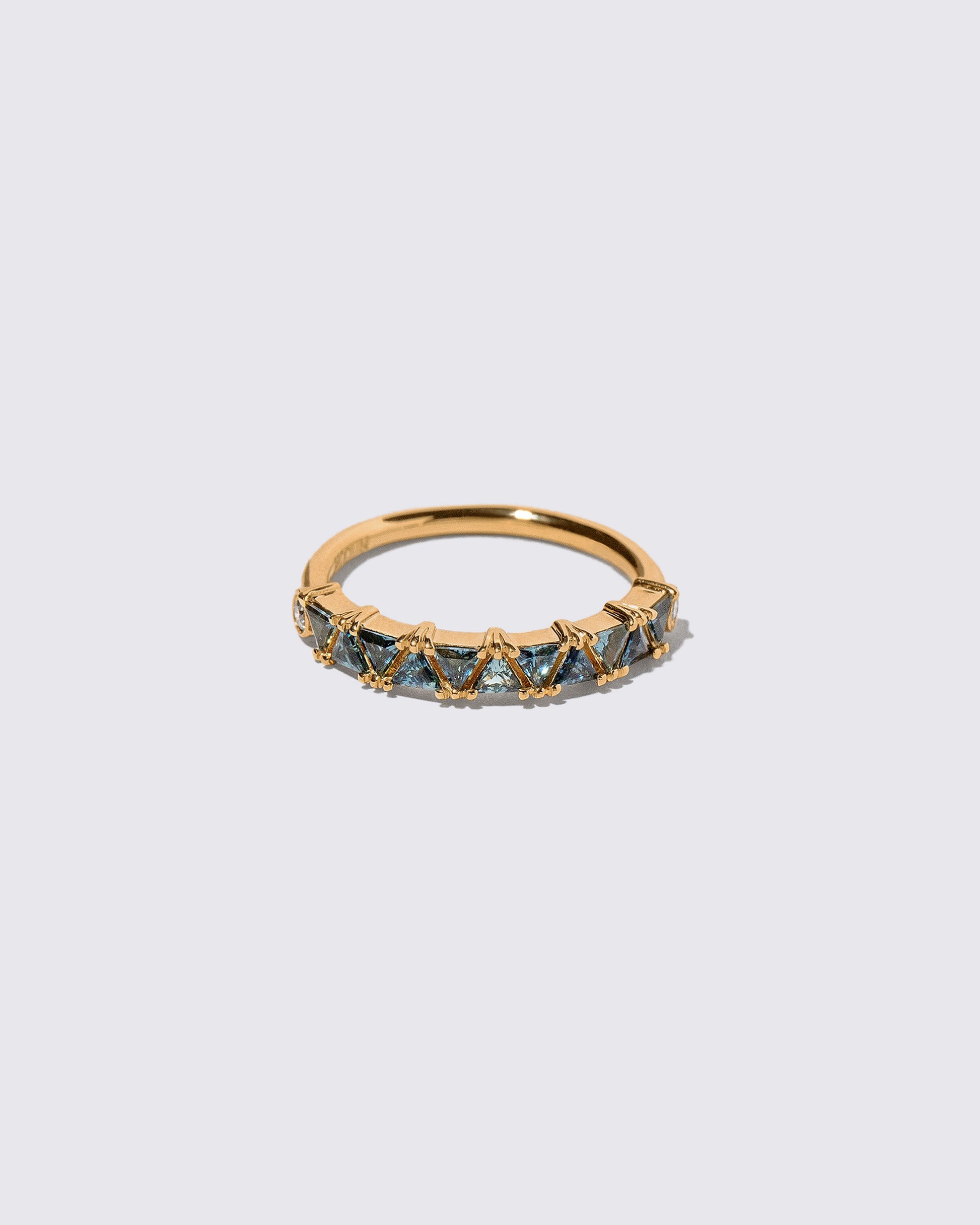 Teal Sapphire Eleven Trillion Ring on light color background.