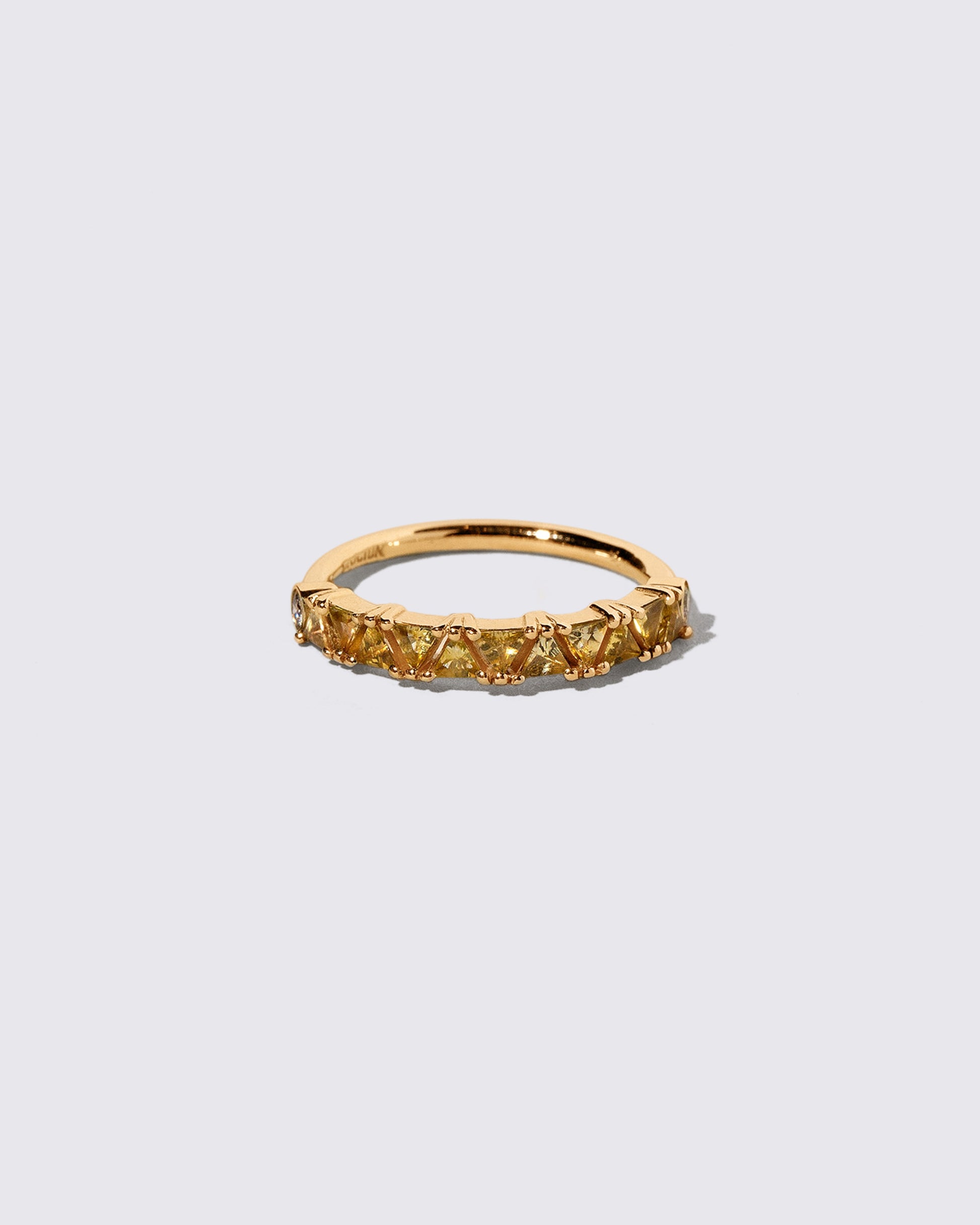 Yellow Sapphire Eleven Trillion Ring on light color background.