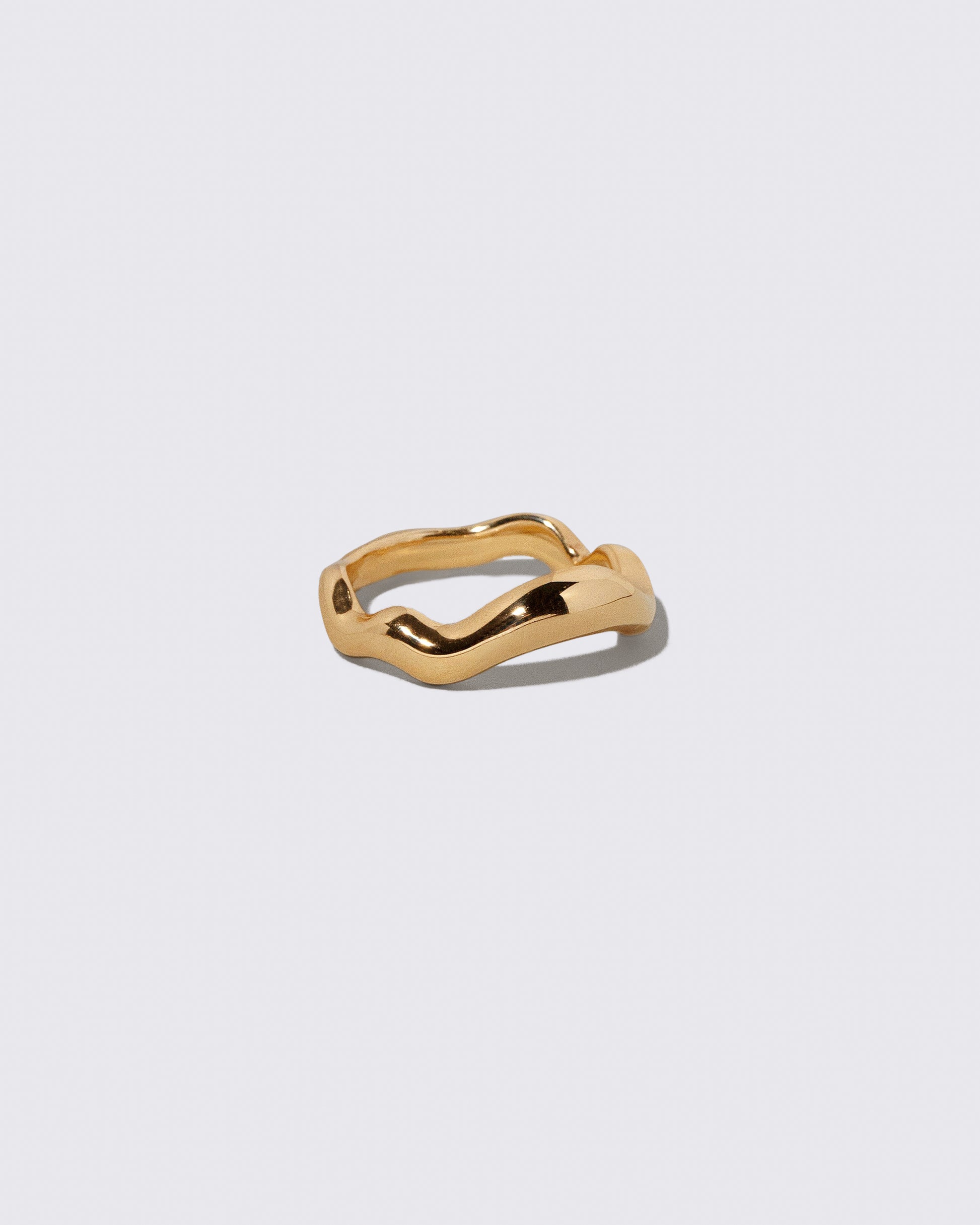 View from the side of the Gold Equalize Band on light color background.