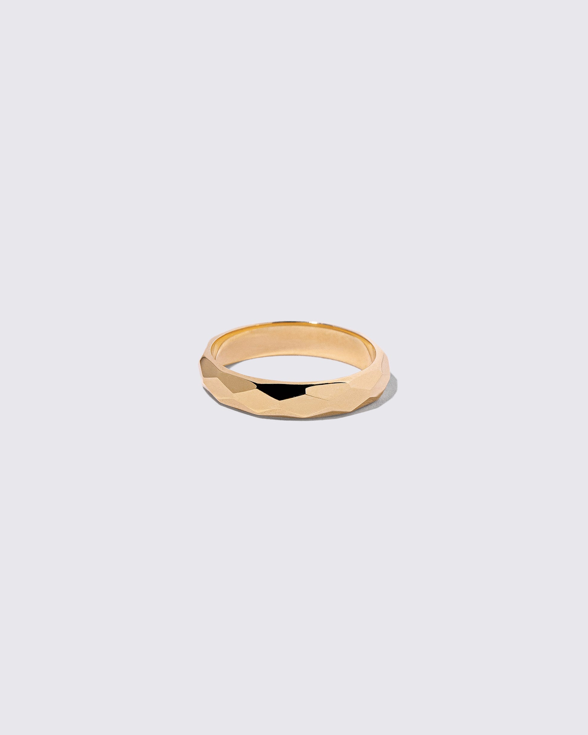 Gold 4mm Facet Band on light color background.