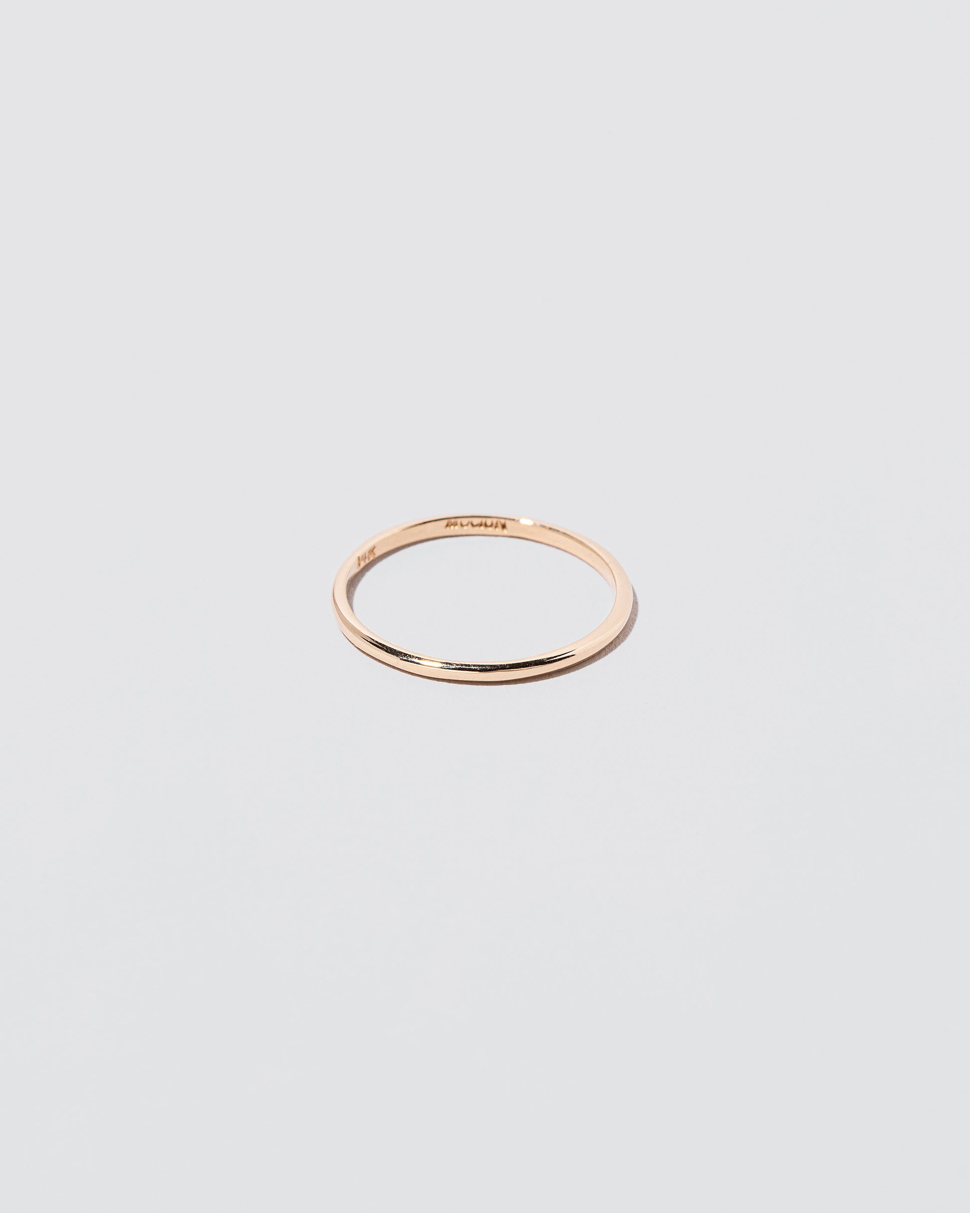Details view of the Gold 1mm Half Round Band on light color background.