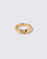Gold Pavé Pinch Band on light color background.