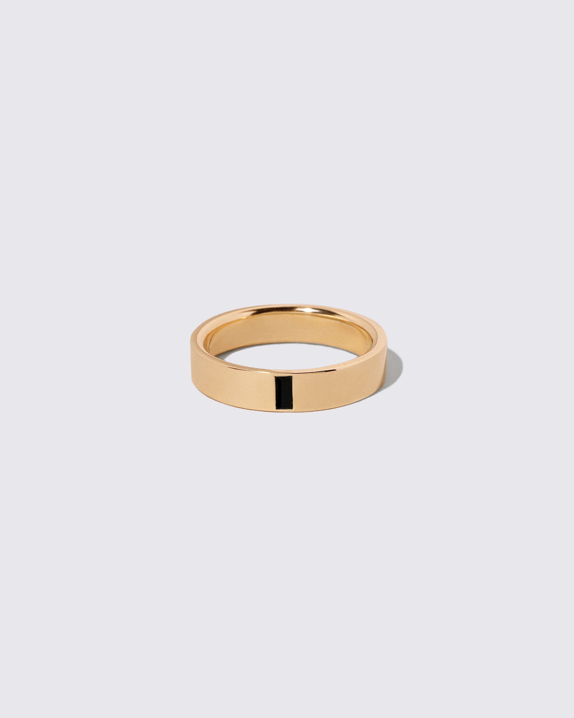 Gold Black Spinel East West 5mm Baguette-Set Piet Band on light color background.