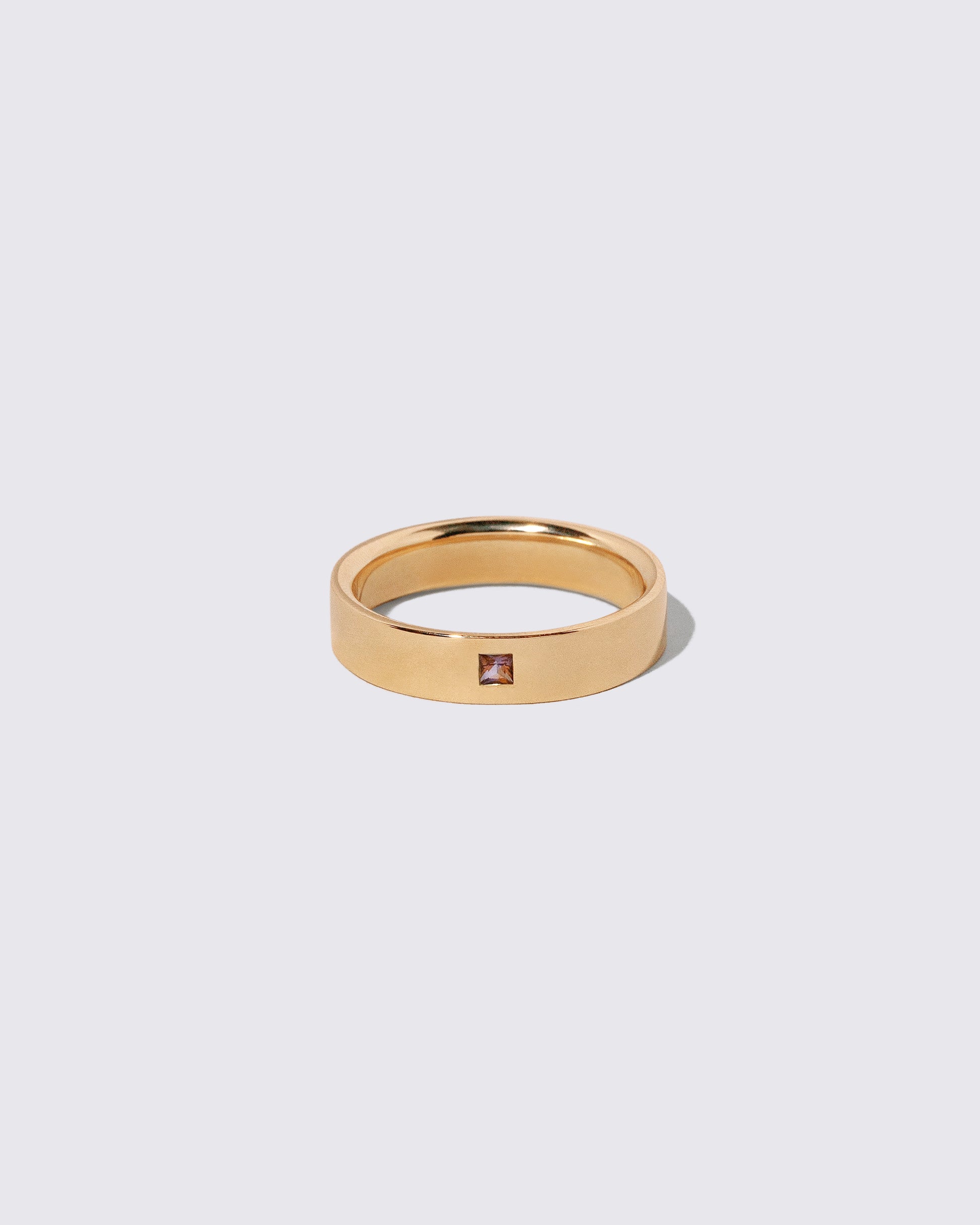 Gold Sri Lankan Bicolor Sapphire 5mm Square Cut Piet Band on light color background.