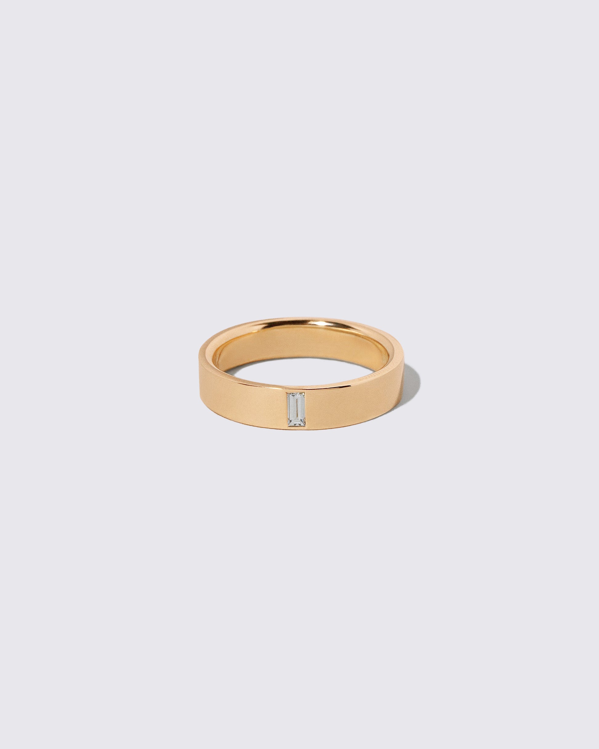 Gold Diamond North South 5mm Baguette-Set Piet Band on light color background.